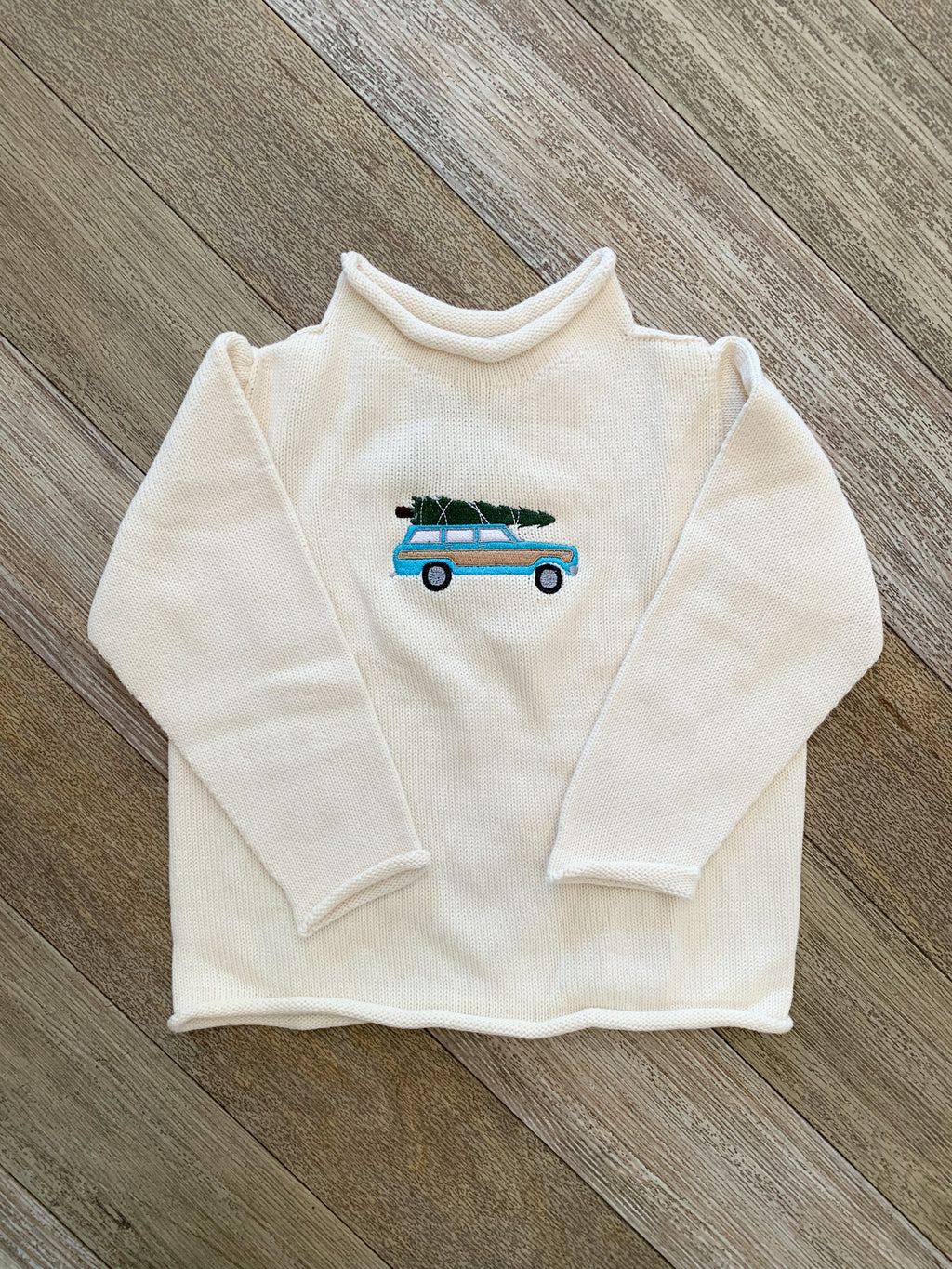 A Soft Idea Roll Neck Sweater in Cream with Woody Wagoneer + Tree